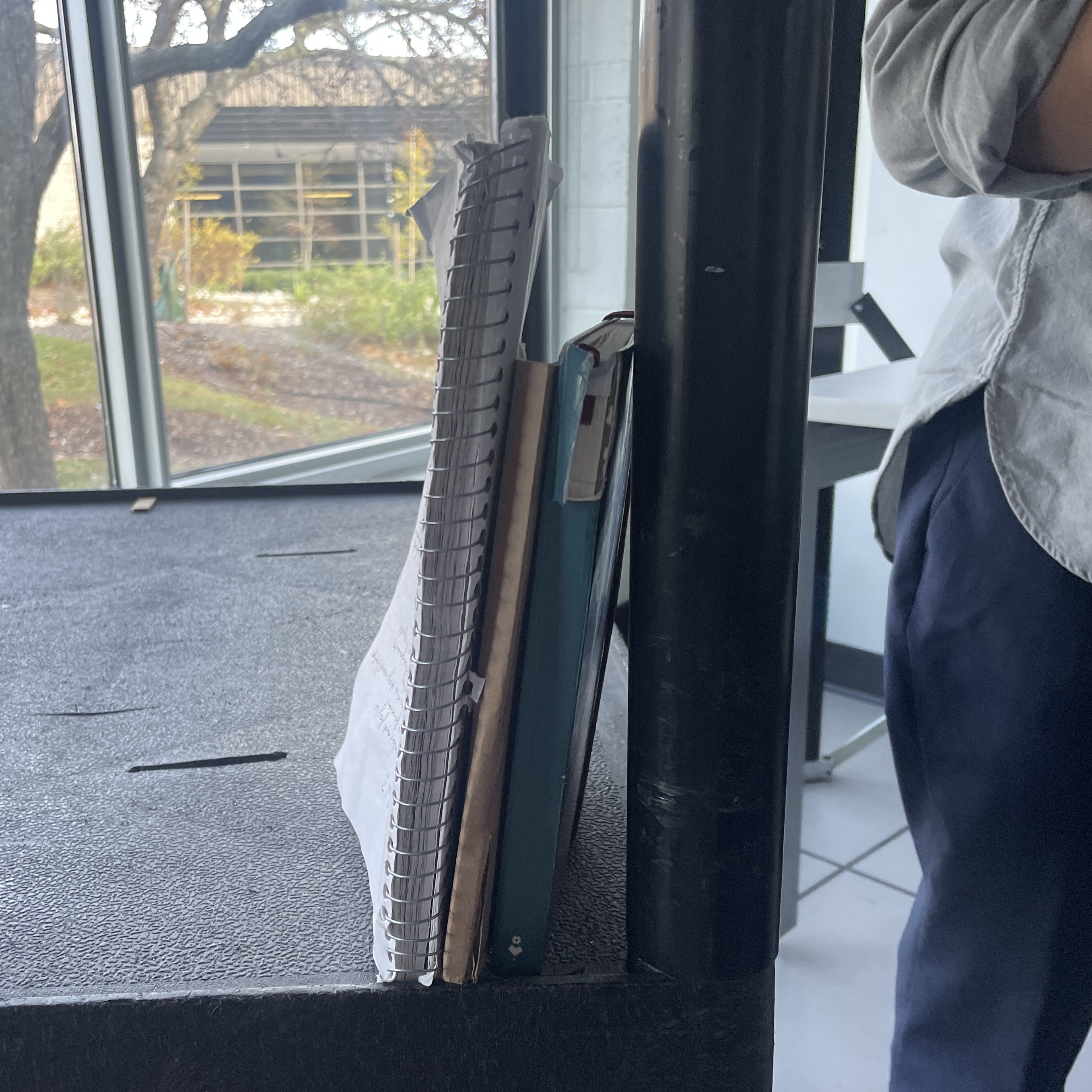 We used a cart as a library shelf. We then used our notebooks and cardboard to represent books.